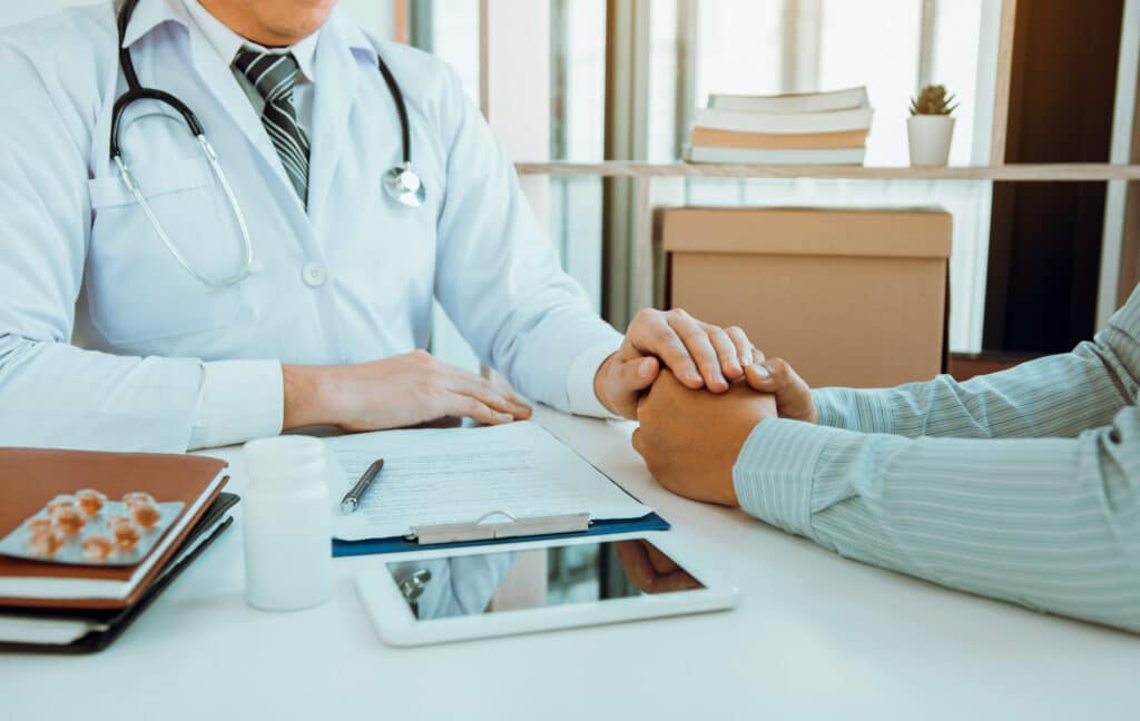 A doctor uses IMS EHR software to help a patient effectively manage a chronic condition.